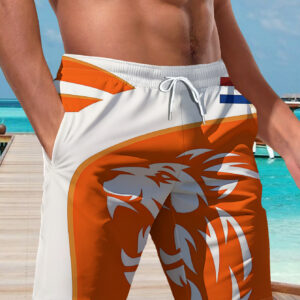 new men's casual shorts with an orange base and a white lion head, featuring the dutch red, white, and blue logo. perfect for festive gatherings and commuting, made from machine washable polyester fabric, suitable for the beach
